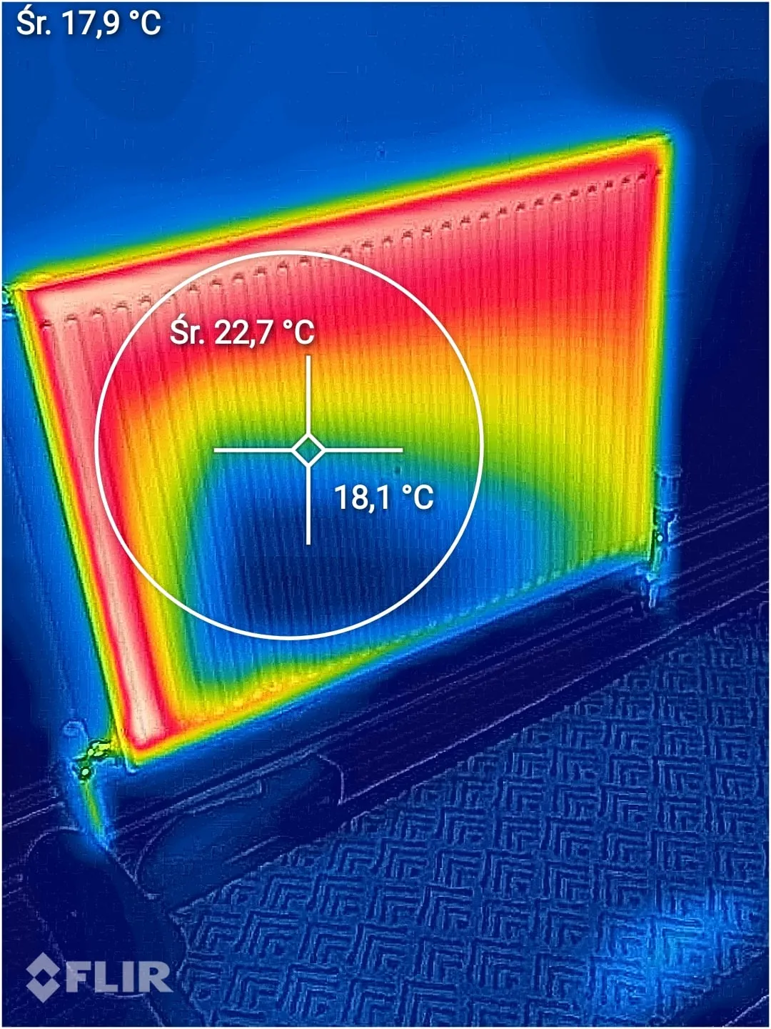 Thermal image of a surface with a cooler patch where moisture has spread, showing spot temperatures of 22.7 and 18.1 degrees